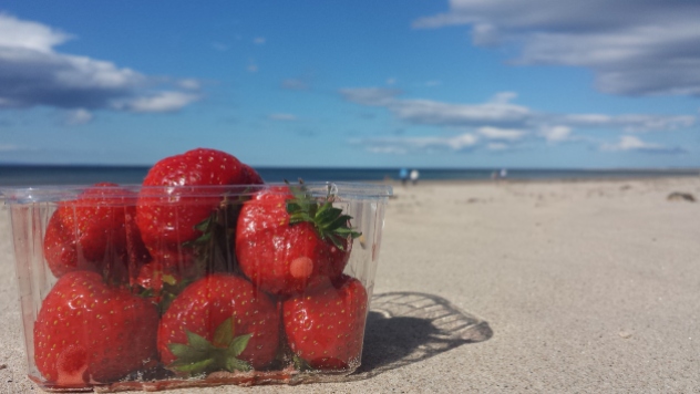 fresh picked strawberries on the beach.
